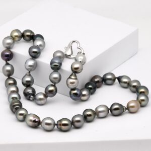 Collier Tetae, 41 perles de Tahiti semi baroques et cerclées de 10 à 11 mm, couleurs naturelles, monté avec nœuds et fermoir cœur en argent rhodié.